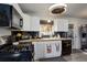 Updated kitchen featuring white cabinets, black appliances, and wood countertops at 8377 Mitze Dr, Denver, CO 80221