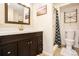 Bathroom featuring a dark wood vanity, white countertops, and a shower with stylish curtain at 7949 W Portland Ave, Littleton, CO 80128