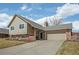 Charming two-story home with attached garage and well-maintained lawn at 7949 W Portland Ave, Littleton, CO 80128