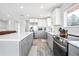 Modern kitchen with stainless steel appliances, island, and stylish cabinetry at 7949 W Portland Ave, Littleton, CO 80128