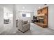 Cozy living room featuring a brick fireplace, neutral carpet, and comfortable seating area perfect for relaxation at 7949 W Portland Ave, Littleton, CO 80128