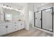 Elegant bathroom featuring a double sink vanity and modern walk-in shower at 1243 Rhett Dr, Erie, CO 80026