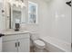 Clean bathroom with white tile and fixtures at 1243 Rhett Dr, Erie, CO 80026