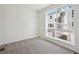 Carpeted bedroom with large window providing natural light and neighborhood view at 1243 Rhett Dr, Erie, CO 80026