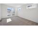 Bright bedroom with large windows and plush carpeting at 1243 Rhett Dr, Erie, CO 80026