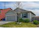 Charming single-story home with a well-maintained lawn, attached garage, and appealing exterior paint at 370 Mesa Ave, Brighton, CO 80603