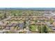 Panoramic aerial view of a neighborhood with lush greenery, and a distant cityscape skyline at 3640 Forest St, Denver, CO 80207