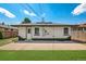 Backyard featuring a concrete patio, green grass, and a well-maintained exterior with black and white paint at 3640 Forest St, Denver, CO 80207