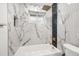 Elegant bathroom with marble tile, and a modern shower head in this serene space at 3640 Forest St, Denver, CO 80207