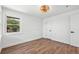 Bedroom featuring a window, wood floors, and a modern light fixture at 3640 Forest St, Denver, CO 80207