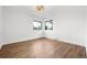 Bright, empty bedroom with wood floors, neutral paint, and two windows at 3640 Forest St, Denver, CO 80207