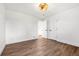 Bright bedroom featuring wood floors, white walls, doors and a decorative light fixture at 3640 Forest St, Denver, CO 80207