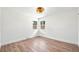 Light, bright bedroom featuring two windows and wood floors at 3640 Forest St, Denver, CO 80207