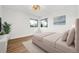 Bright bedroom with two windows, wood floors, modern lighting, and neutral paint at 3640 Forest St, Denver, CO 80207