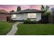 Charming single-story home with a well-manicured lawn and inviting walkway to the front door at sunset at 3640 Forest St, Denver, CO 80207