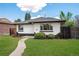 Charming single-story home with a well-manicured lawn and inviting walkway to the front door at 3640 Forest St, Denver, CO 80207
