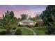Charming single-story home with a well-manicured lawn and inviting walkway to the front door at sunset at 3640 Forest St, Denver, CO 80207