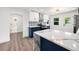 Modern kitchen featuring a large island, stainless steel appliances, and stylish blue and white cabinetry at 3640 Forest St, Denver, CO 80207