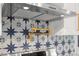 Kitchen features modern stainless steel hood, pot filler, and blue patterned backsplash at 3640 Forest St, Denver, CO 80207