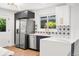 Kitchen with stainless steel appliances, white countertops, and blue lower cabinets by a bright window at 3640 Forest St, Denver, CO 80207