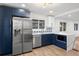 Modern kitchen with stainless steel appliances, quartz countertops, and blue cabinets with gold hardware at 3640 Forest St, Denver, CO 80207