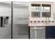 Close-up of the kitchen featuring stainless steel appliances and modern fixtures by a bright window at 3640 Forest St, Denver, CO 80207