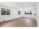 Unfurnished living room with hardwood flooring, large windows offering views, and abundant natural light at 3640 Forest St, Denver, CO 80207