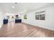 Spacious open-concept living room with hardwood flooring, recessed lighting, and large windows for ample natural light at 3640 Forest St, Denver, CO 80207