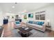Bright living room featuring a modern sofa, stylish decor, and plenty of natural light from the windows at 3640 Forest St, Denver, CO 80207