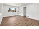 Bright, unfurnished living room with hardwood floors, a front door, and large windows providing natural light at 3640 Forest St, Denver, CO 80207