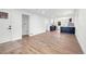 Open-concept living area with access to laundry, displaying hardwood flooring and seamless flow to kitchen at 3640 Forest St, Denver, CO 80207