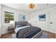 Bedroom with a large window, mountain themed pictures and modern furniture at 3640 Forest St, Denver, CO 80207