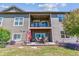Relaxing backyard with a covered patio, balcony, lush lawn, and landscaping at 6948 W Jewell Dr, Lakewood, CO 80227