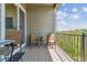 Outdoor balcony featuring a wooden deck, railing with a view, and seating with a small table at 6948 W Jewell Dr, Lakewood, CO 80227