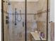 Tiled shower with sleek black fixtures and glass door, and a built in bench at 6948 W Jewell Dr, Lakewood, CO 80227