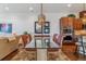Dining room features hardwood floors, modern lighting, and flows into the living area at 6948 W Jewell Dr, Lakewood, CO 80227