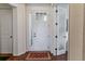 Bright entryway featuring a white front door with glass sidelights and hardwood flooring at 6948 W Jewell Dr, Lakewood, CO 80227