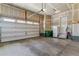 Spacious garage with a wide overhead door and lots of room for parking and storage at 6948 W Jewell Dr, Lakewood, CO 80227