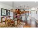 Open concept dining and kitchen area with stainless steel appliances and granite countertops at 6948 W Jewell Dr, Lakewood, CO 80227