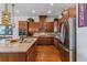 Spacious kitchen featuring stainless steel appliances, granite countertops, and wooden cabinets at 6948 W Jewell Dr, Lakewood, CO 80227