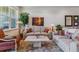 Bright living room with neutral colored furniture and a view of decorative mirrors on the wall at 6948 W Jewell Dr, Lakewood, CO 80227