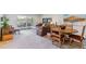 Open living area with a dining table set, sofa, chair, piano, and access to an outdoor patio at 6948 W Jewell Dr, Lakewood, CO 80227