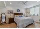Bright main bedroom with natural light, carpet, decorative pillows, and a wall mirror at 6948 W Jewell Dr, Lakewood, CO 80227