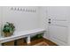 Entryway mud room with bench, coat hooks, and storage baskets for organization at 6948 W Jewell Dr, Lakewood, CO 80227