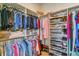 Organized walk-in closet with hanging rods, shelving, and clear storage containers at 6948 W Jewell Dr, Lakewood, CO 80227