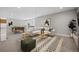 Finished basement provides ample space for entertaining with an area rug, furniture, and a pool table at 17054 Hop Clover Ave, Parker, CO 80134