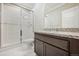 Bathroom featuring a tiled shower with glass door, granite counters, modern vanity, and contemporary fixtures at 17054 Hop Clover Ave, Parker, CO 80134