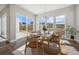 Modern dining room with stylish wood chairs, area rug, and a sliding door to the patio at 17054 Hop Clover Ave, Parker, CO 80134