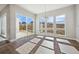 Bright dining area with large windows and a sliding door to the backyard patio at 17054 Hop Clover Ave, Parker, CO 80134