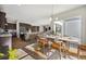 Bright dining area with hardwood floors, modern chandelier, and views into the kitchen, great for Gathering meals at 17054 Hop Clover Ave, Parker, CO 80134